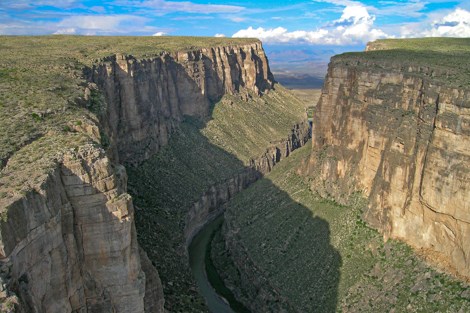 A view from above of the Rio Grande flowing through the high limestone walls of Santa Elena Canyon