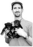 Dave Onorato holding two bear cubs