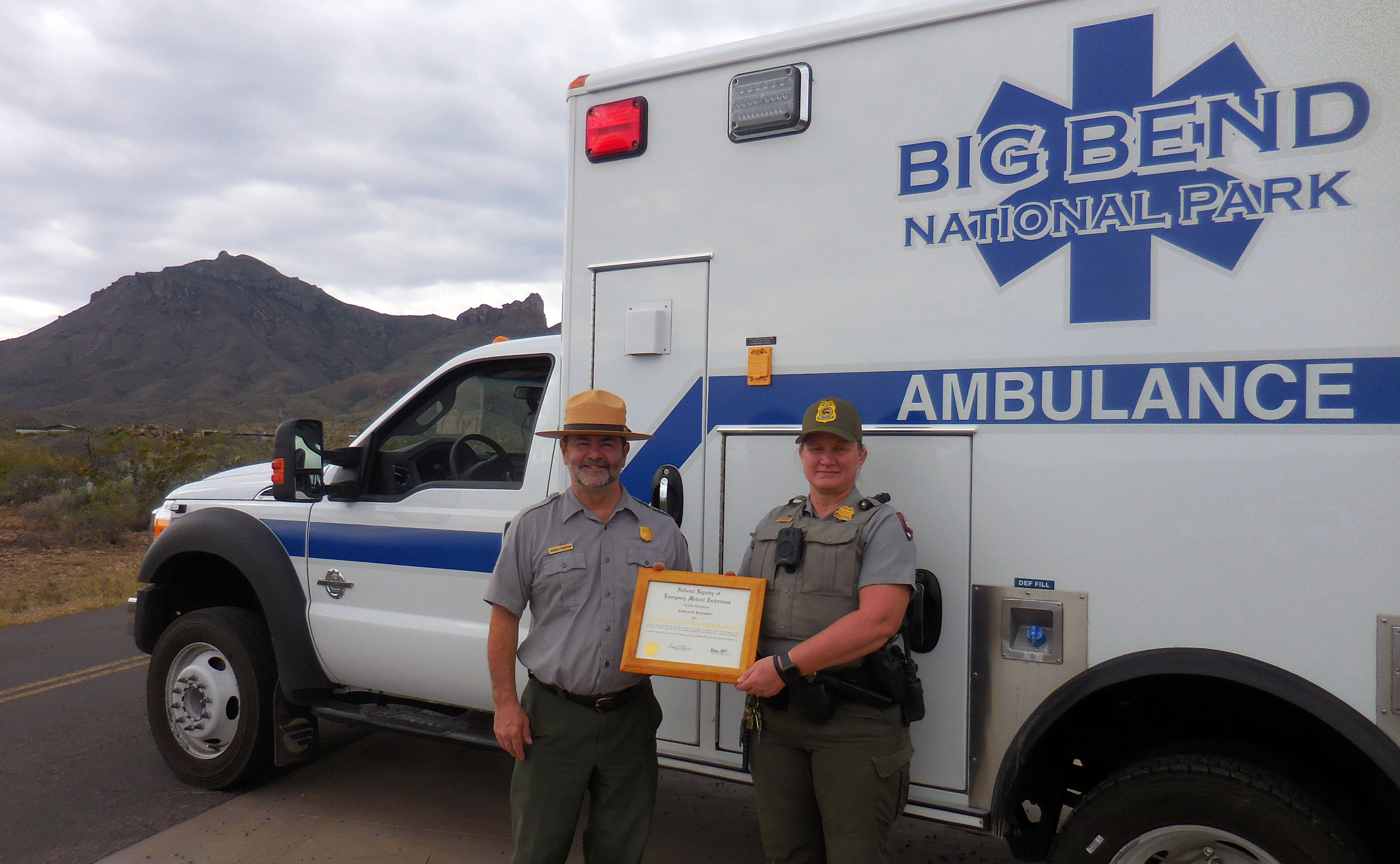Superintendent Kendell Thompson presents Ranger Buckingham with EMT award