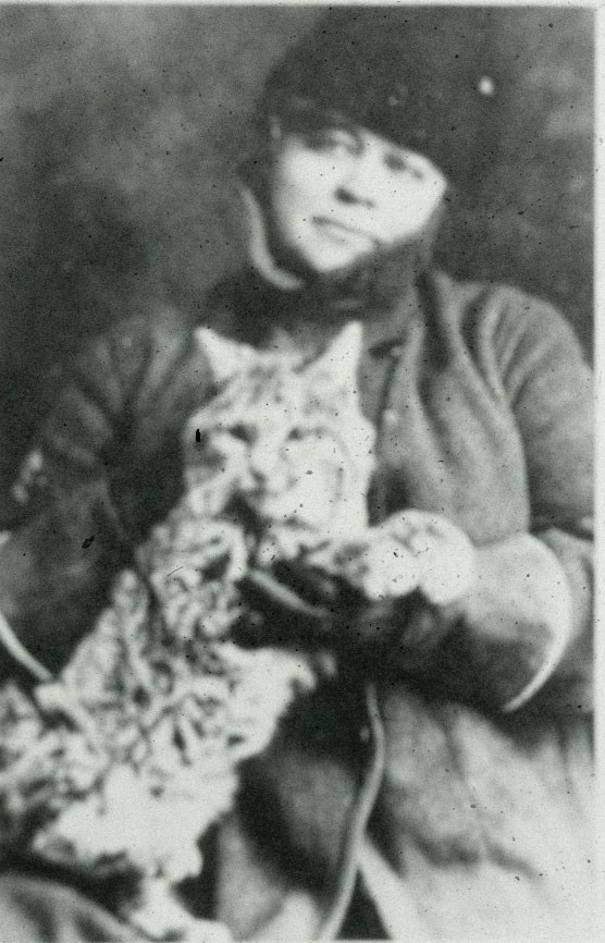 Caroline Lockhart dressed in winter coat holding her pet bobcat Wampy
