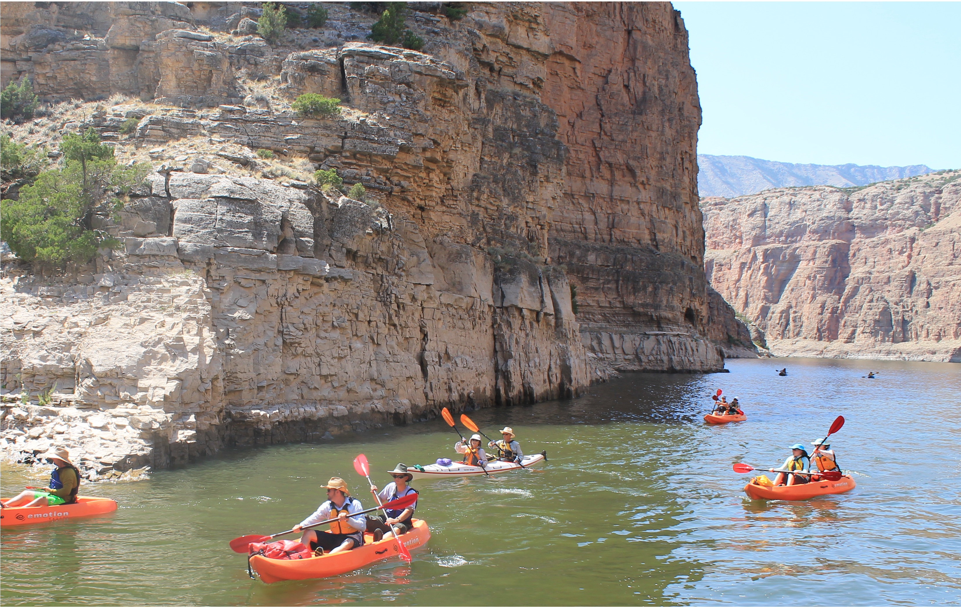 Kayak Tour in Bighorn Canyon 7 Kayaks with 11 people paddling up river in Bighorn Canyon.