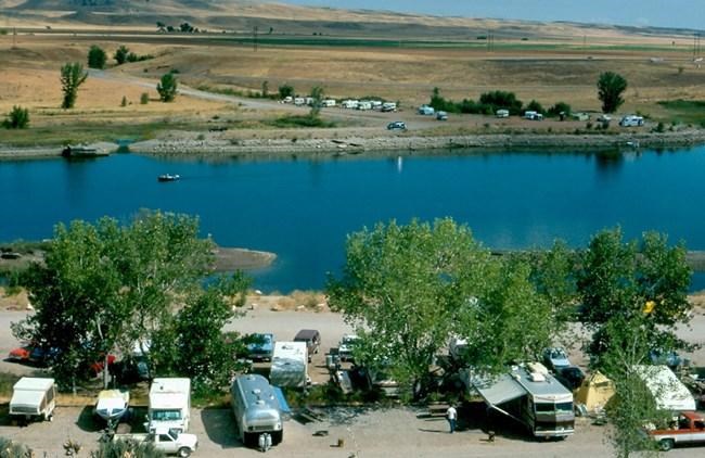 Afterbay Campground Afterbay campground with many campers on both sides of the Bighorn River.