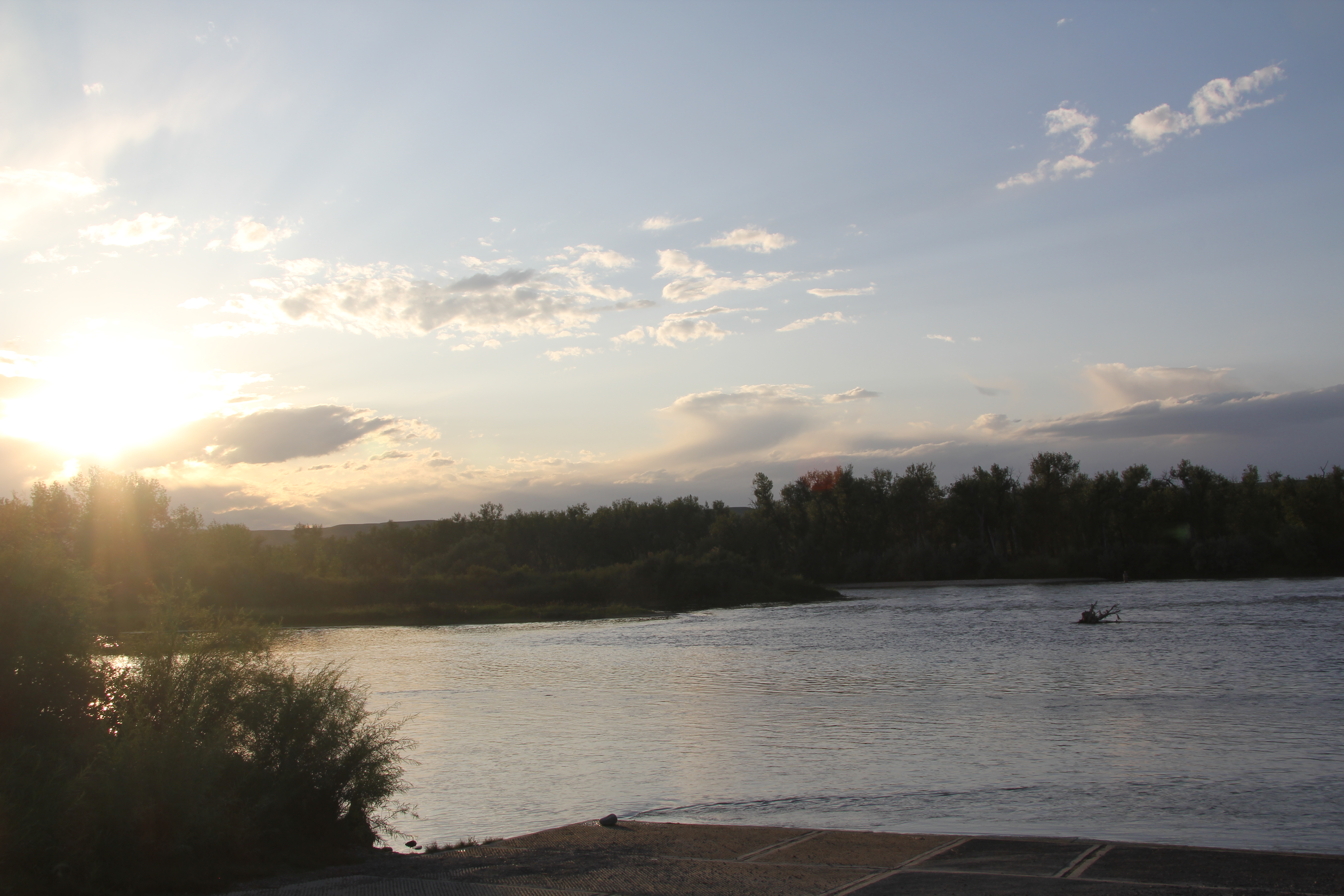 A drift boat at 3 mile access at sunset