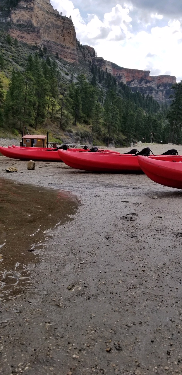 Three red kayaks on the beach near the Black Canyon comfort station.