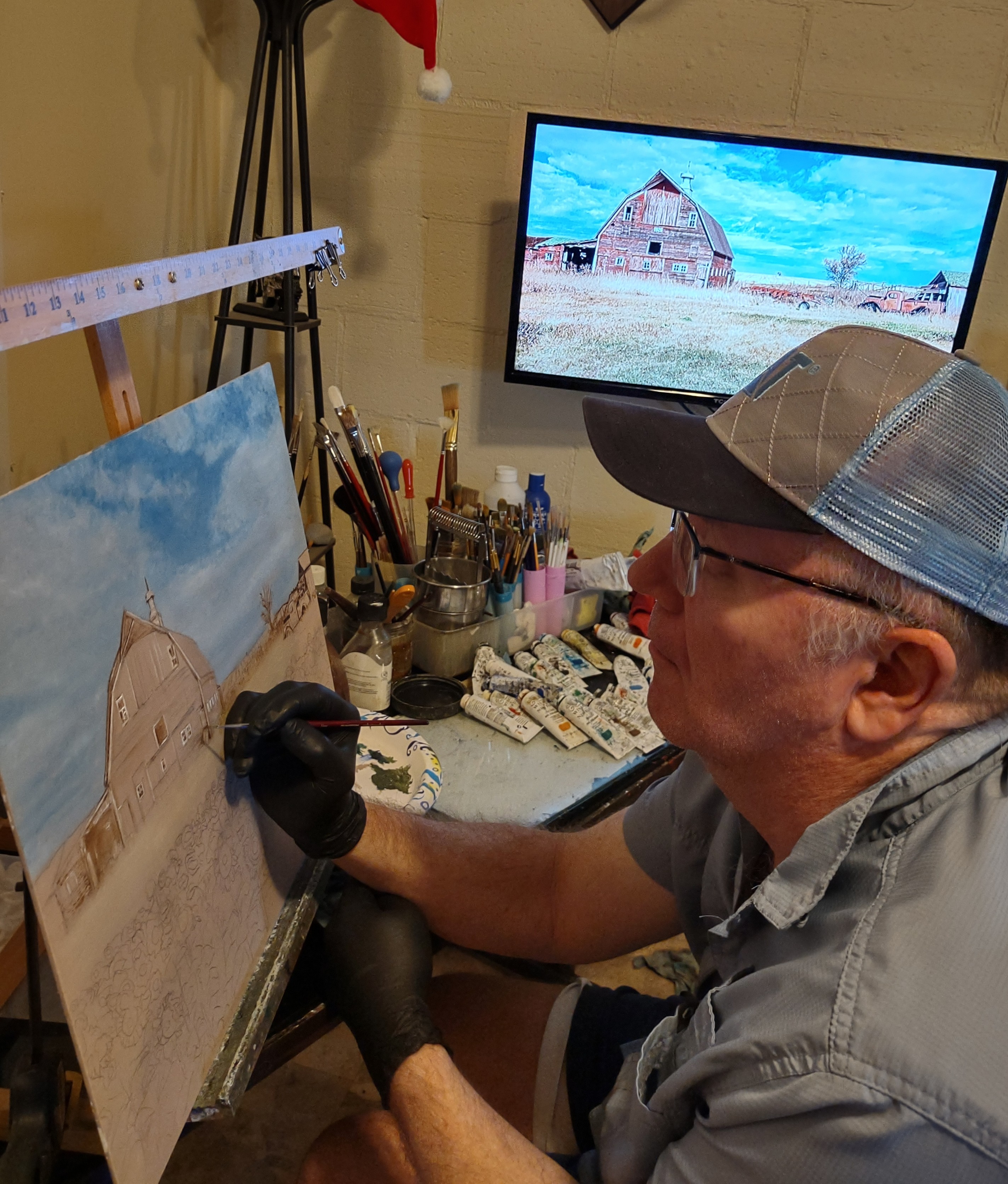 Mike Hansen working on barn painting in studio Mike Hansen working on barn painting in his studio.