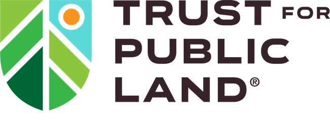 A stylized shield with a sun and mountains. Trust for Public Land is to the right of the shield.