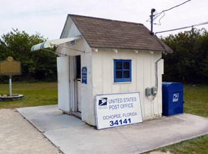 A tiny shed with a sign that says, "United States Post Office Ochopee Florida 34141."
