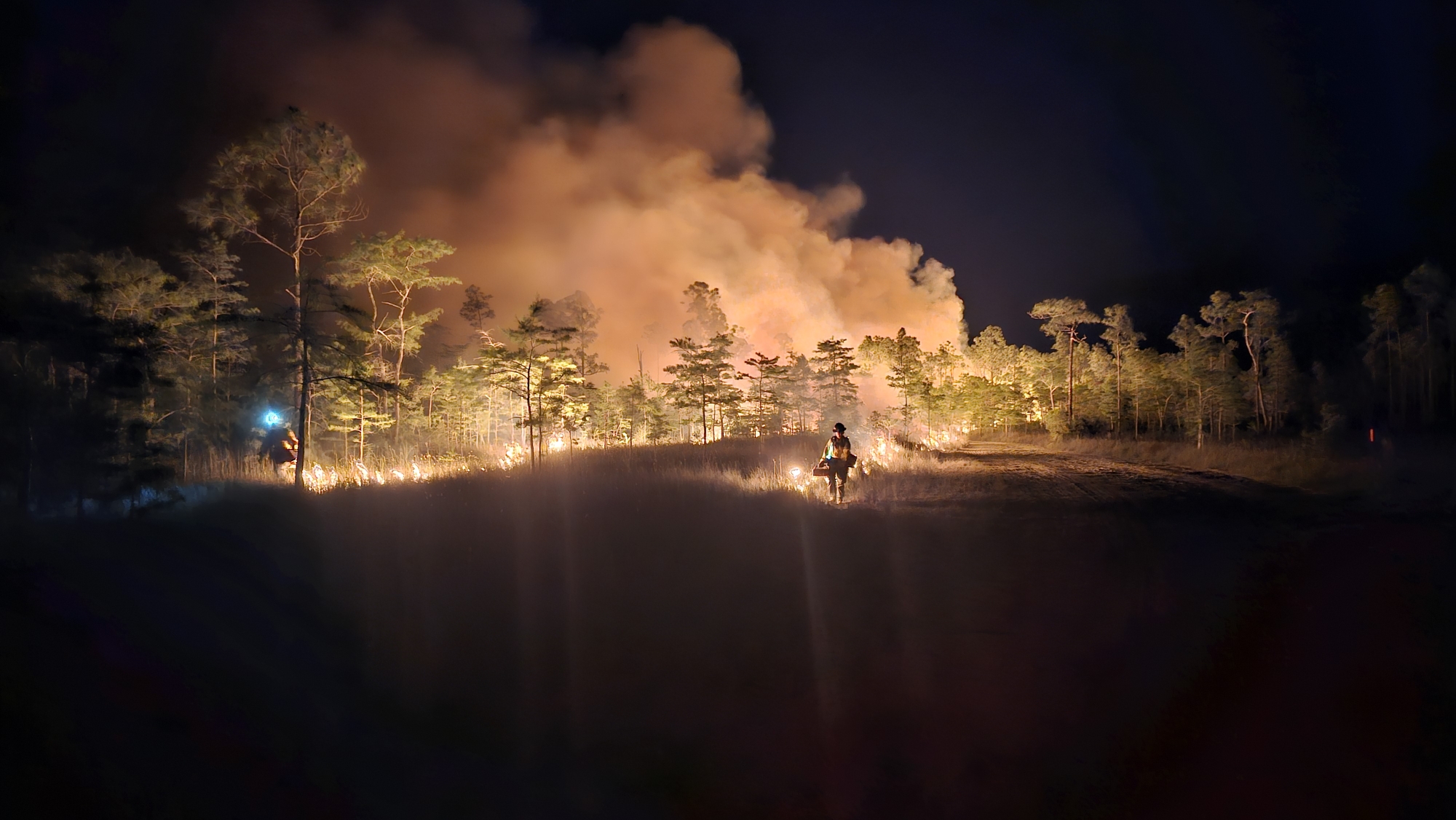 Firefighter conducts nighttime burnout operations