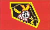 A red flag with  flag of the Nez Perce nation with a black and white drawing of a bust of Chief Joseph ringed by the phrase "Nez Perce Tribe" above and "Treaty of 1855".