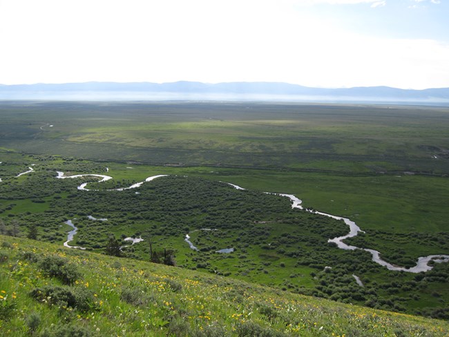 A river from high above with the mountains in the background.