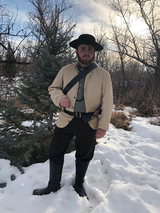 Austin Haney Austin Haney in period dress standing in front of trees in the snow