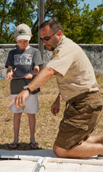 Volunteer Roger Boone helps a Family Fun Fest participant learn about marine archaeology. Volunteer Roger Boone helps a Family Fun Fest participant learn about marine archaeology.