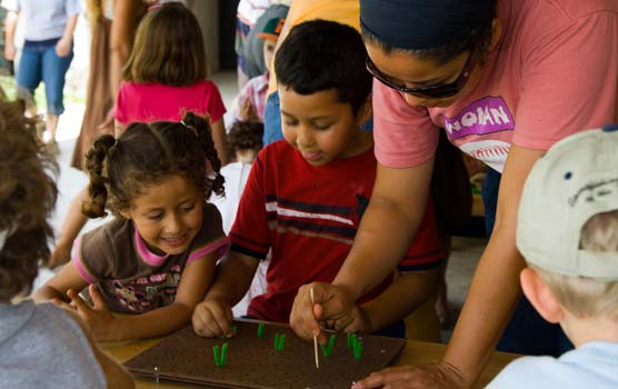 A mother and her kids "plant pineapples" at Family Fun Fest