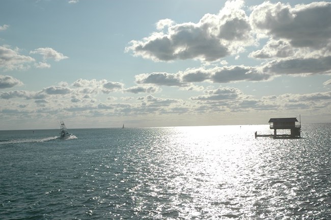 Morning in Stiltsville Morning in Stiltsville, a boat heading towards open water.