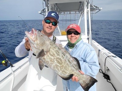 Captain Matt Lofton and Mary Muratori with a black grouper Captain Matt Lofton and Mary Muratori with a black grouper