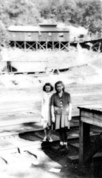 Two people standing by the loading dock at the Blue Heron company store.