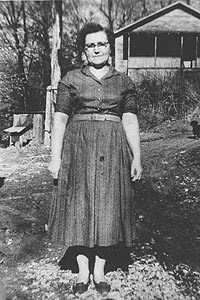 Gerti Ledbetter standing in front of house in Blue Heron.