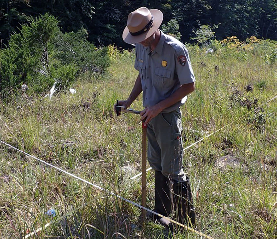 Park biologist inventorying plants on a cobble bar Park biologist inventorying plants on a cobble bar