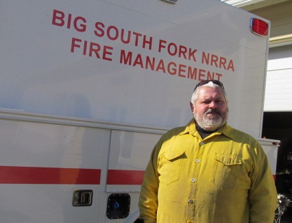 Tommy Barnes standing next to fire engine