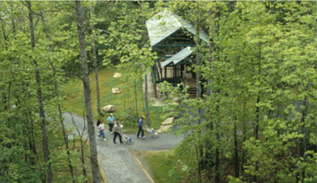 people walking up sidewalk towards a ghost structure at Mine 18