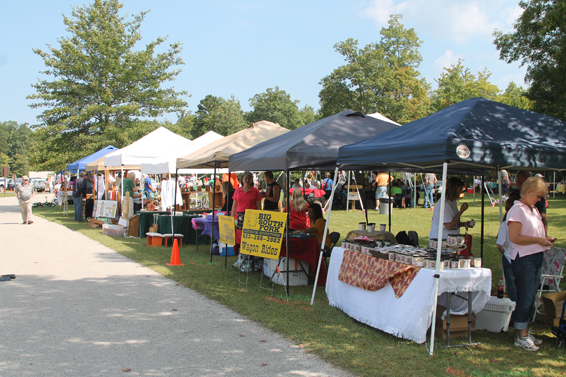 Crafters lined up along road at festival