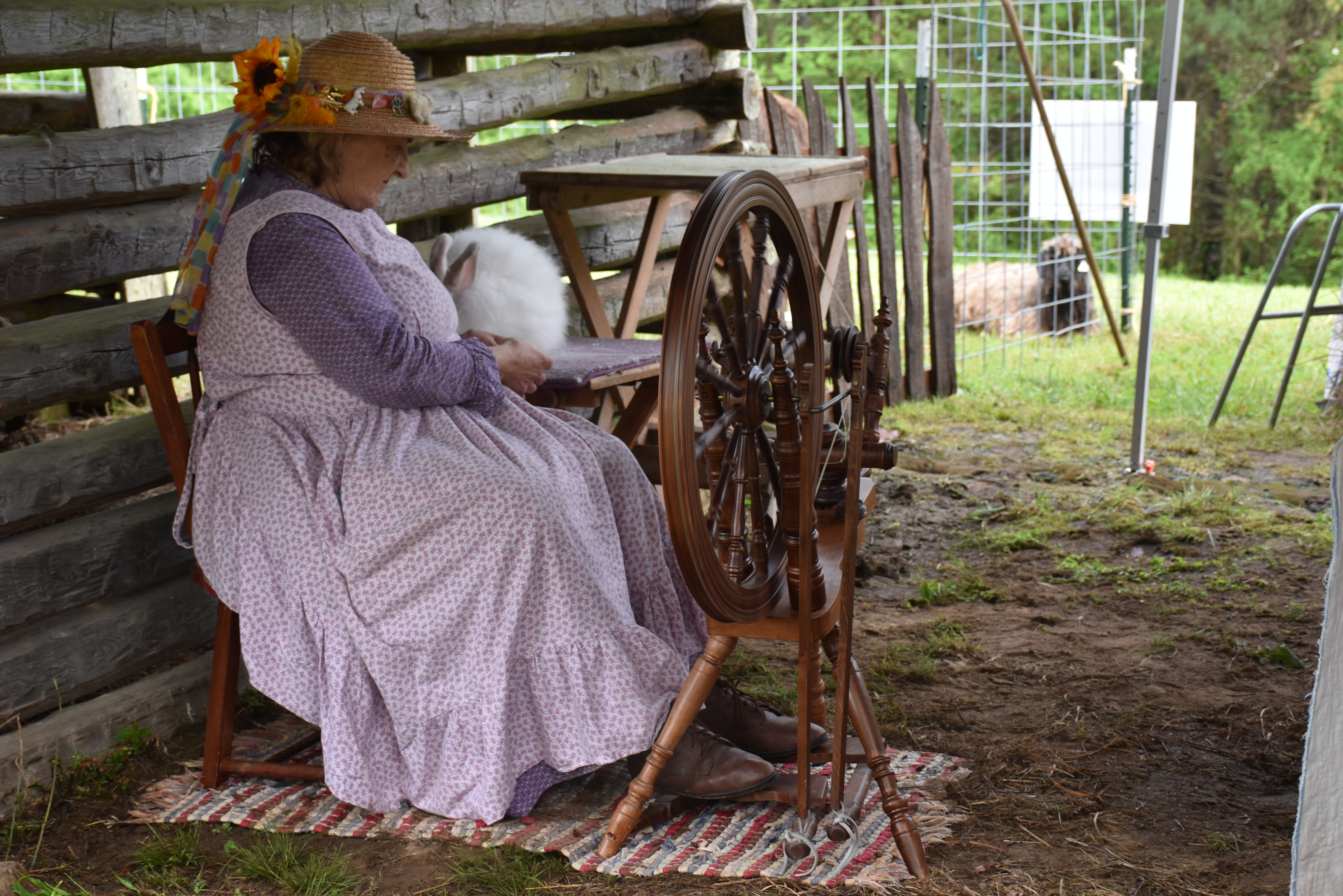 A woman sitting down demonstrating how to spin.