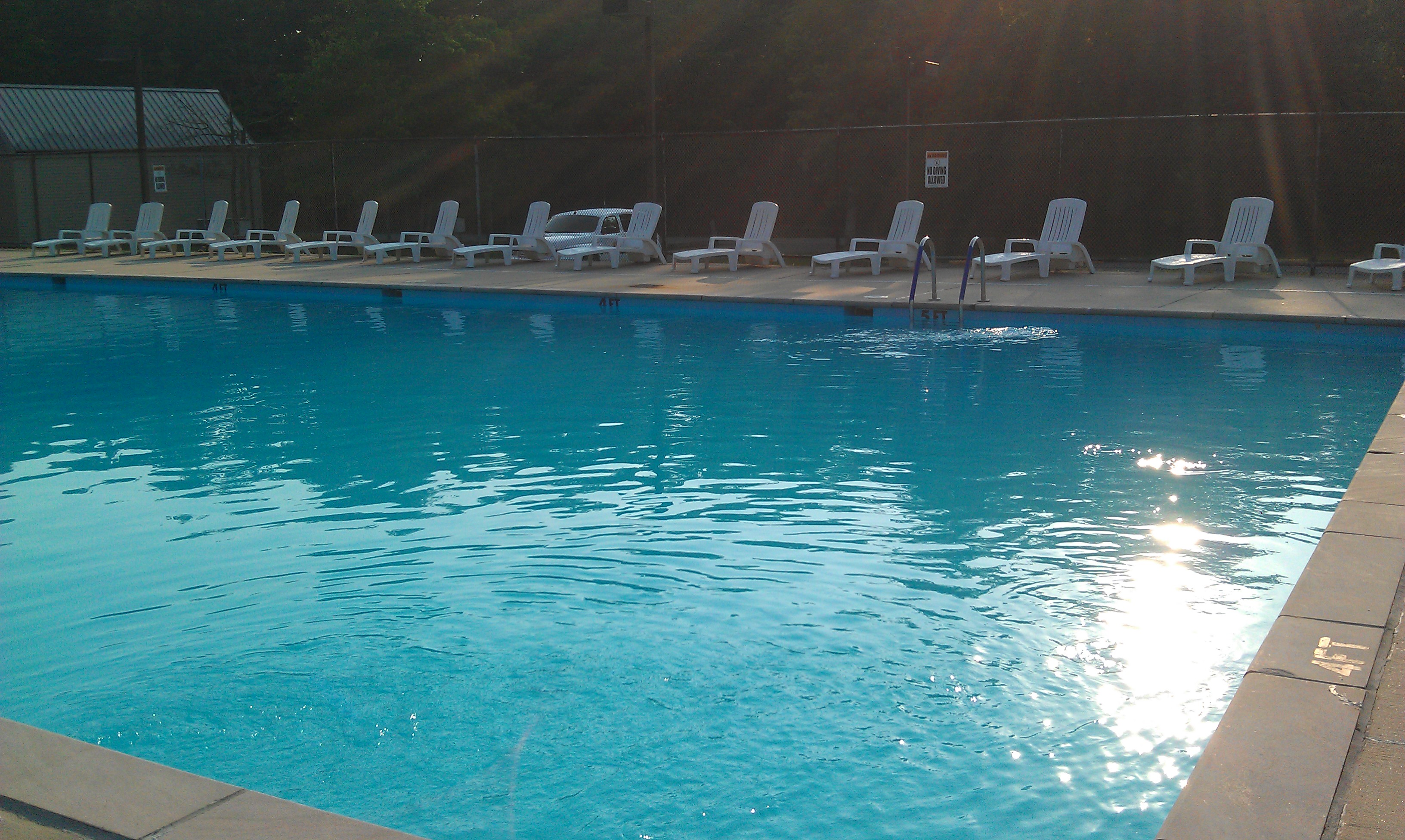 blue water sparkling in pool next to chair