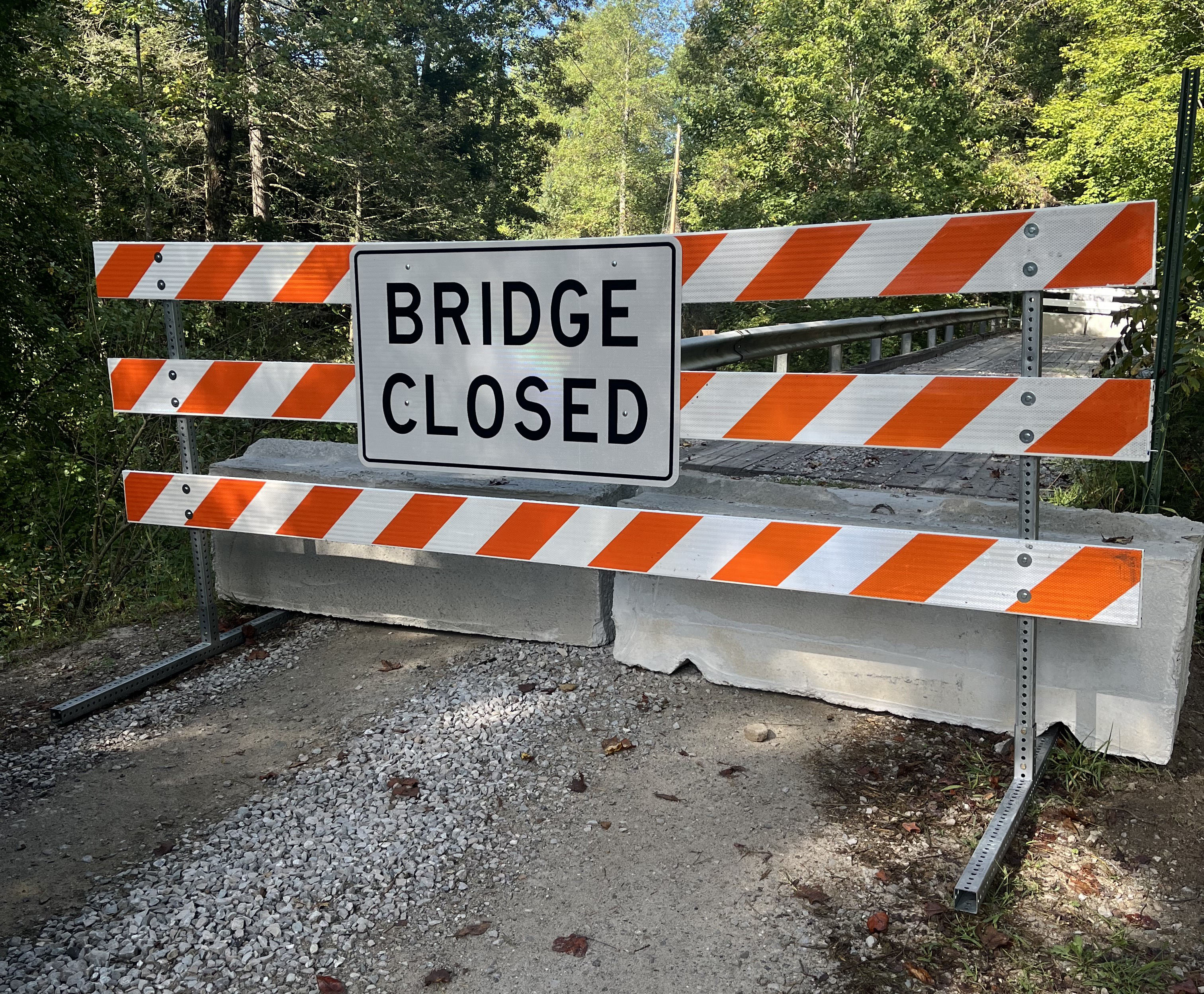 Road Closed Caution gate reading Bridge Closed