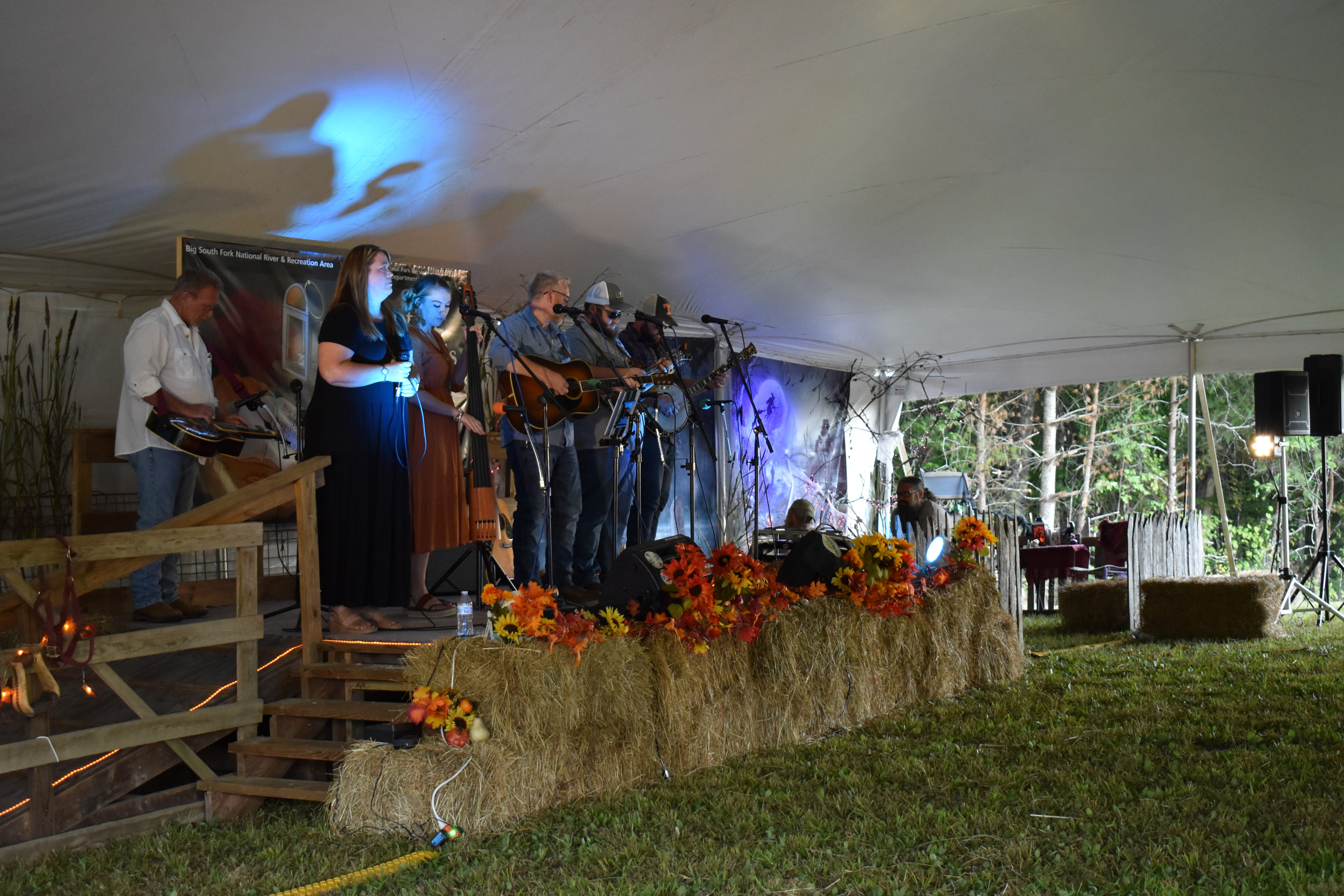 Musicians performing on a stage in front of audience