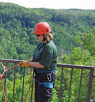 Member of local rescue squad rigs for rappel.