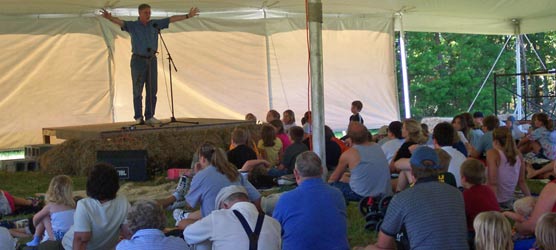 storyteller on stage in front of crowd