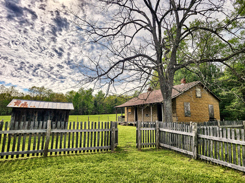 Old building on a farm with fence wrapping it