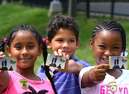 Fourth graders proudly showing their passes