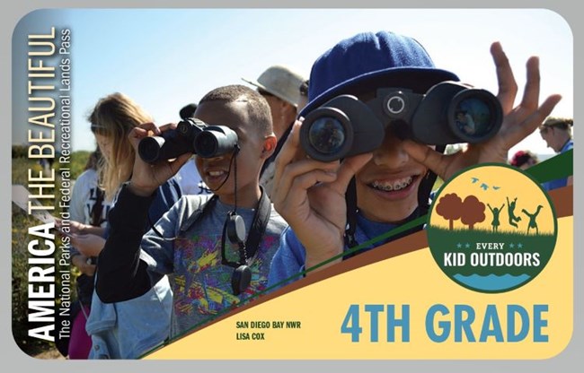 Kids outdoors looking through binoculars.