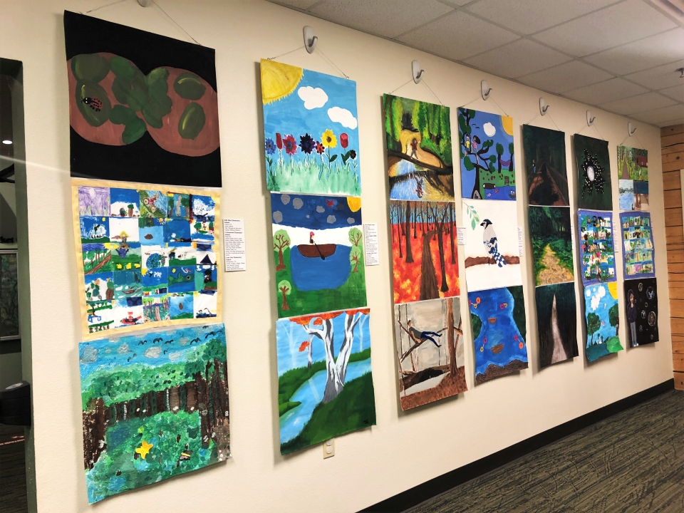 Student artwork colorful artwork hanging inside a room