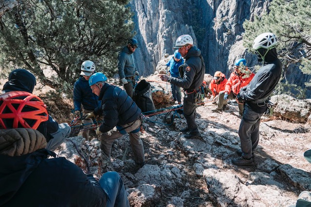 rescue team at top of dramatic canyon prepare ropes for rescue rescue team at top of dramatic canyon prepare ropes for rescue