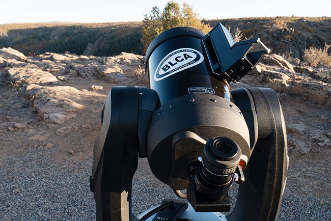large black telescope with a sticker that says "BLCA," the park acronym