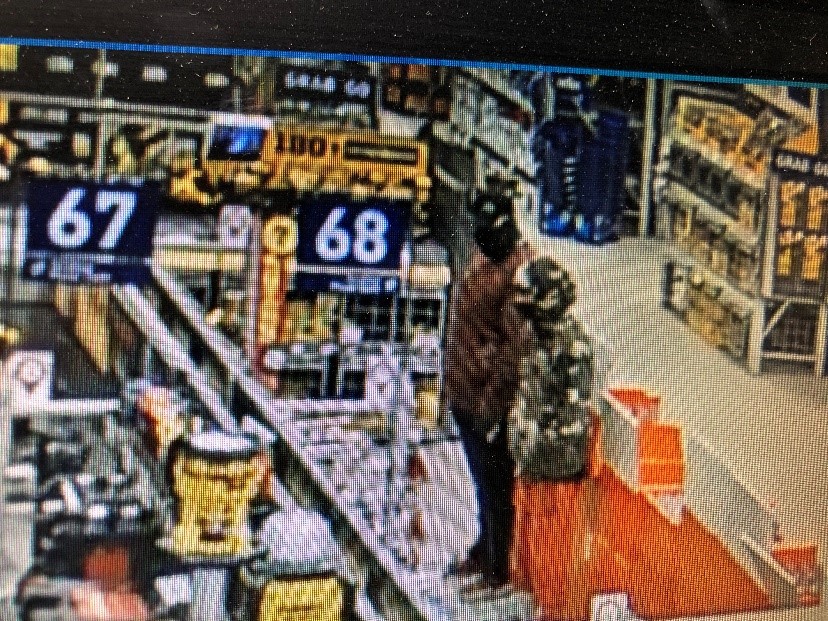 Two men stand in a retail store. Two men stand in a retail store.