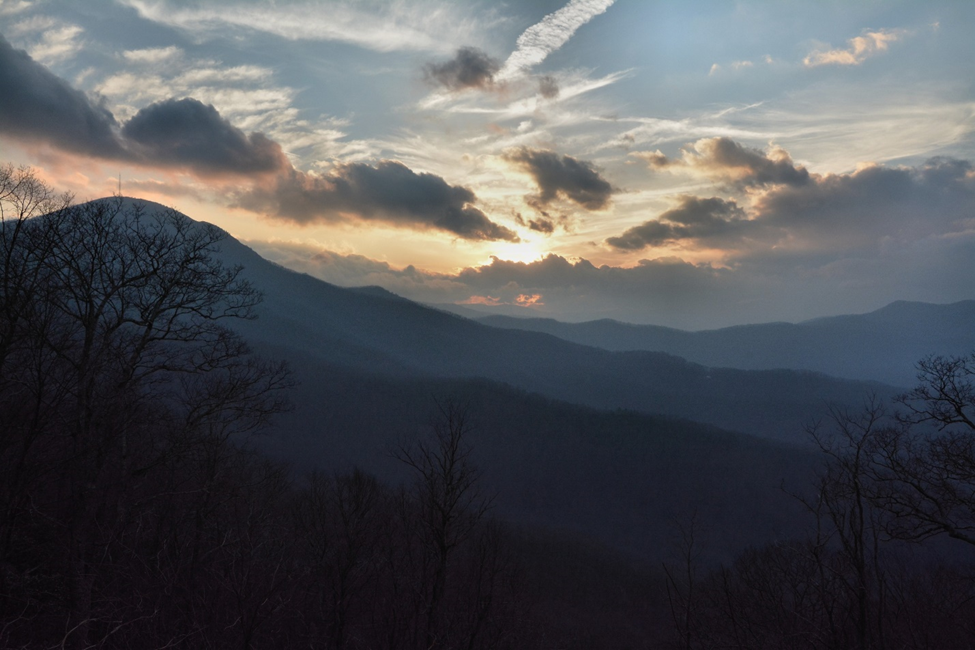 Sunset over Mount Pisgah Looking out over blue mountains covered in trees at sunset