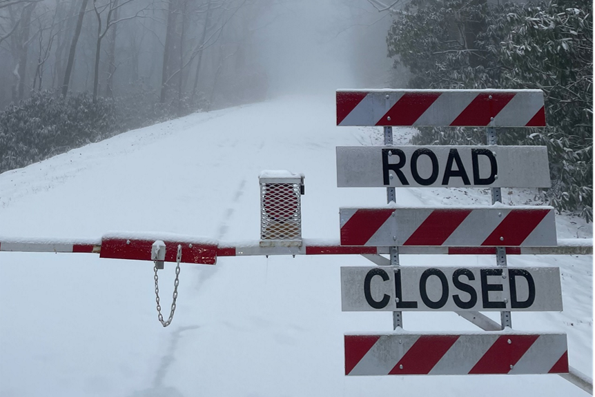 closure gate with snow and fog