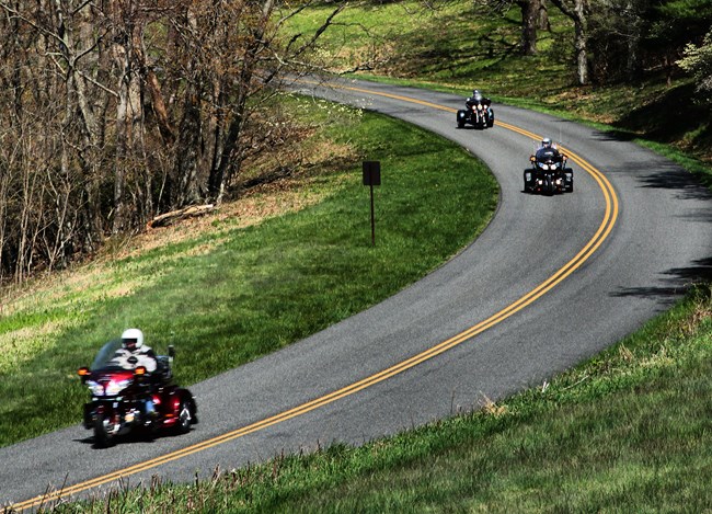 Motorcycles round a curve on the Blue Ridge Parkway motor road