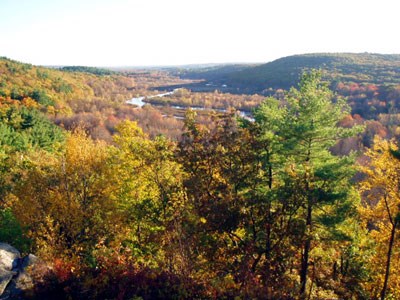 Blackstone River meandering through valley with fall foliage.