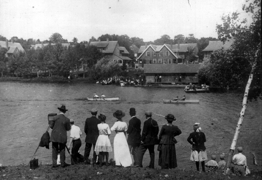 People watching a canoe race in Hopedale mill pond