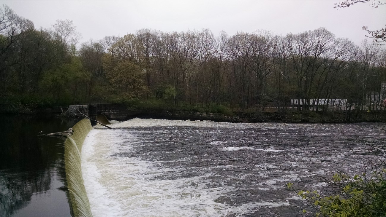 Dam along the Blackstone River with water rolling over it