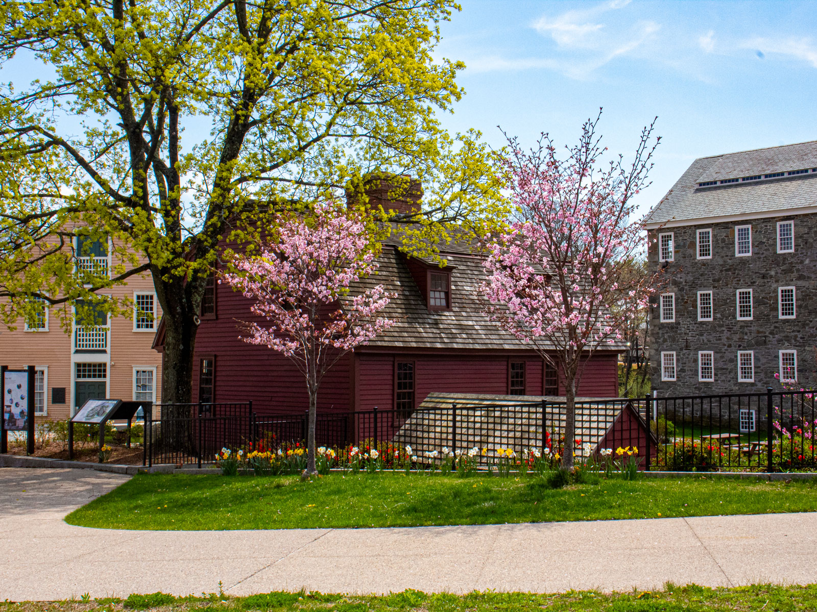 Cara Retouched Three historic buildings with budding green and pink trees in the foreground