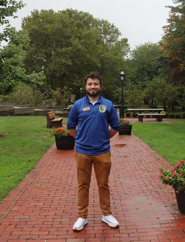 Man standing in blue shirt with NPS logo