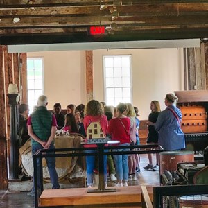 Fall Walkabouts. Group of people standing in front of a ranger inside Slater Mill.