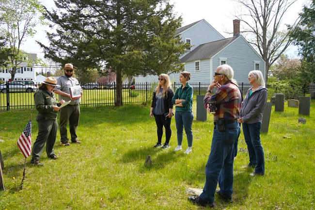 Horrocks Tour2 Two Rangers standing in cemetery with group of visitors