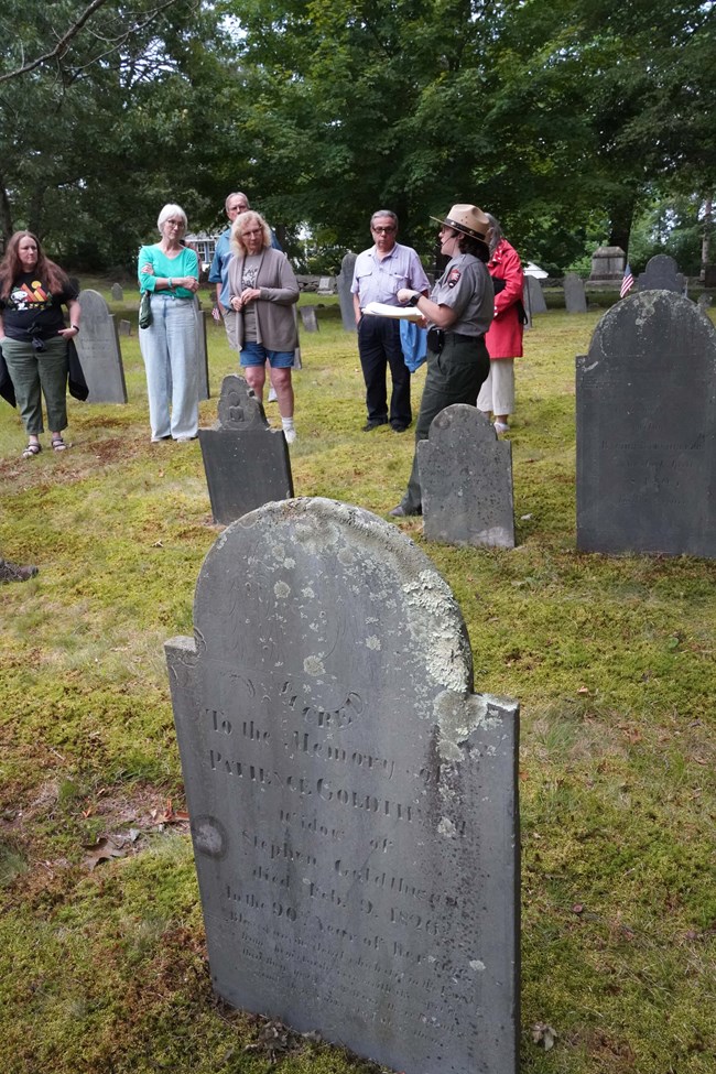Ranger Wlakabout Group of visitors stand in cemetery listening to Park Ranger speak