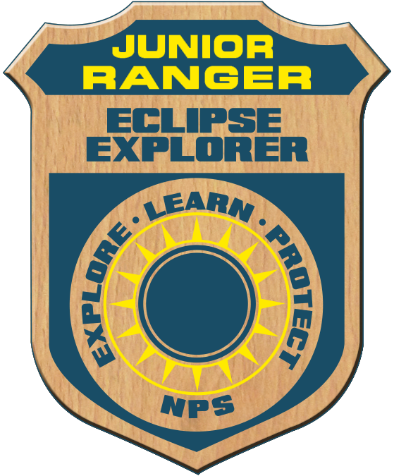 lt= A badge with text Junior Ranger Eclipse Explorer